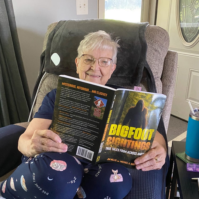 mom-with-bigfoot-book Mike Kozlowski on football field
